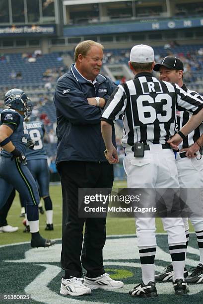 Head Coach Mike Holmgren of the Seattle Seahawks talks with referee Bill Carollo and side judge John Parry before the game against the San Francisco...