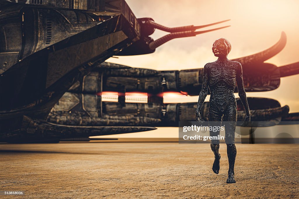 Alien with spaceship, walking in desert