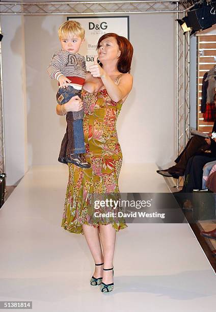 Natasha Hamilton and one of her children attend the D&G AW04 children's fashion show in association with Vogue Bambini and Barnardo's, at Harrods...