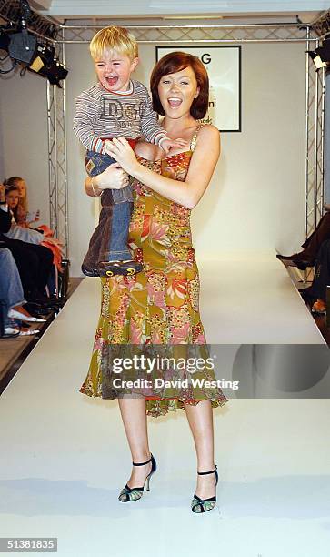 Natasha Hamilton and one of her children attend the D&G AW04 children's fashion show in association with Vogue Bambini and Barnardo's, at Harrods...