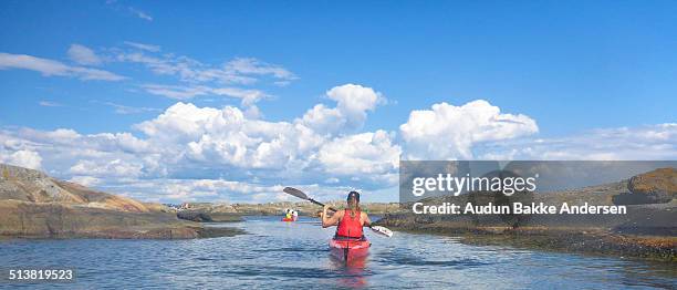 a female kayak paddler manoevring between islands - buskerud stock pictures, royalty-free photos & images