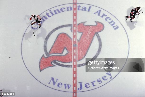 Overhead view of New Jersey Devils logo on center ice as the Buffalo Sabres and New Jersey Devils skate during warm-ups prior to their game at...