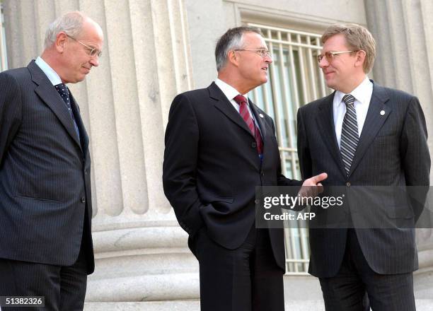 German Finance Minister Hans Eichel talks with his Russian counterpart Alexei Kudrin as Dutch Finance Minister Gerrit Zalm, shortly before they posed...