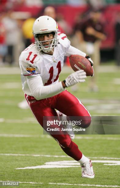 Larry Fitzgerald of the Arizona Cardinals runs for yardage during the game against the Atlanta Falcons at the Georgia Dome on September 26, 2004 in...