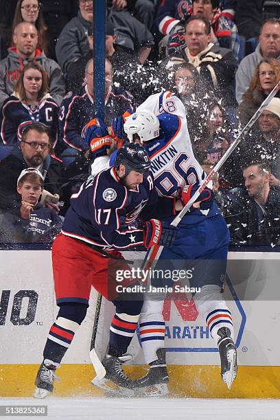 Brandon Dubinsky of the Columbus Blue Jackets avoids a check by Nikita Nikitin of the Edmonton Oilers during the second period of a game on March 4,...