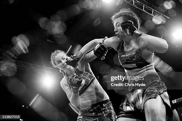 Jordina Baars and Steph Glew exchange punches during the Cage Muay Thai 8 bout at Logan Metro Sports Centre on March 4, 2016 in Brisbane, Australia.