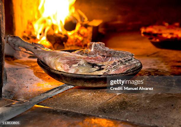 roasting the lamb - roast lamb stock pictures, royalty-free photos & images