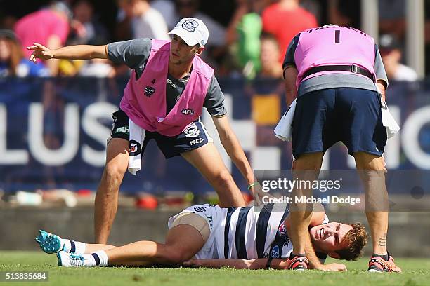 Jackson Thurlow of the Cats reacts after a leg injury during the 2016 AFL NAB Challenge match between the Essendon Bombers and the Geelong Cats at...