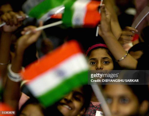 Indian school children wave the national flag to welcome the President of India A.P.J.Abdul Kalam to a function in Madras, 02 October 2004, The...