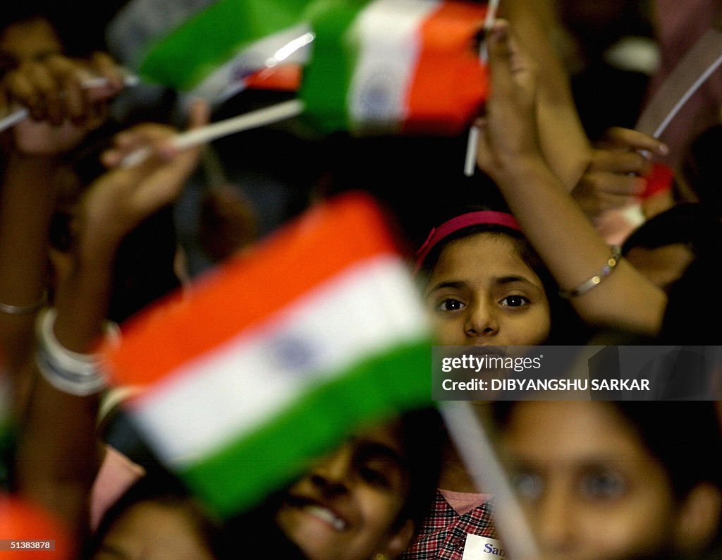Indian school children wave the national