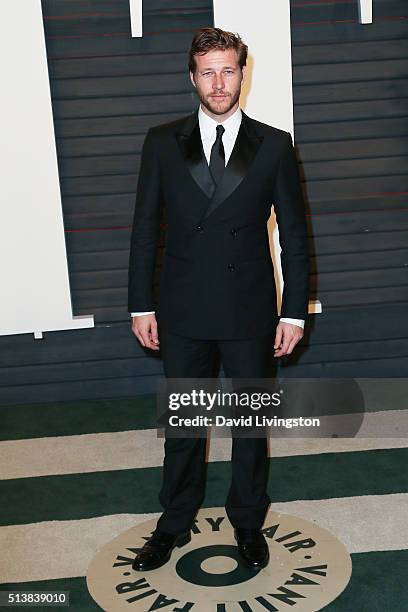 Actor Luke Bracey arrives at the 2016 Vanity Fair Oscar Party Hosted by Graydon Carter at the Wallis Annenberg Center for the Performing Arts on...