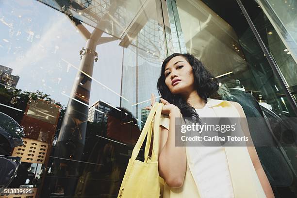 well dressed woman shopping outside of a mall - luxury handbag stock pictures, royalty-free photos & images