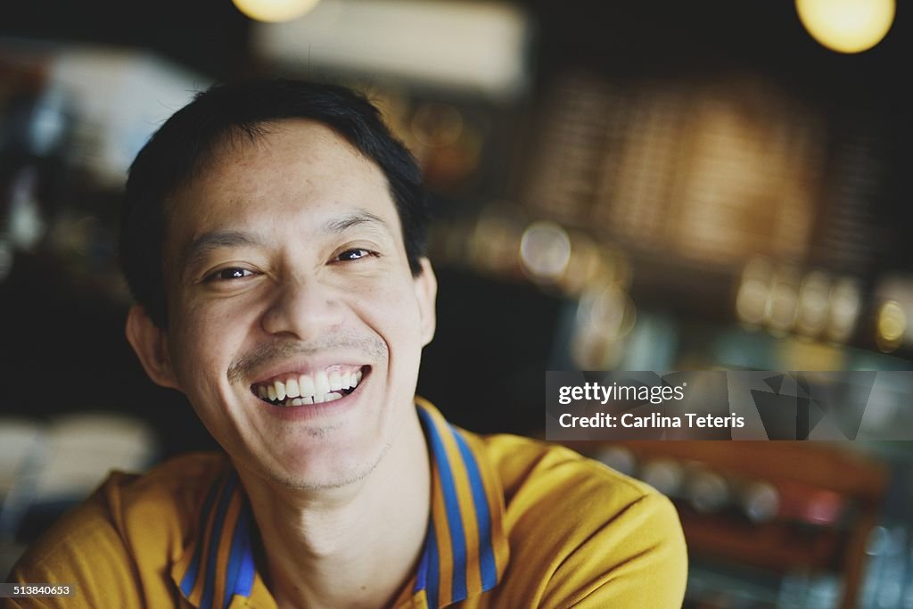 Man smiling in a cafe