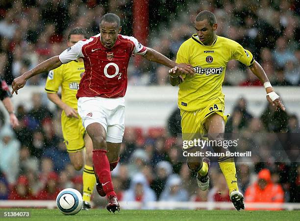 Thierry Henry of Arsenal battles with Jonathan Fortune of Charlton Athletic during the Barclays Premiership match between Arsenal and Charlton...