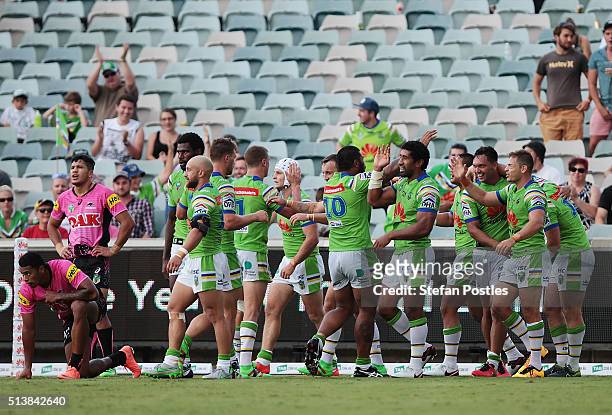 Raiders players celebrate after Shaun Fensom scored a try during the round one NRL match between the Canberra Raiders and the Penrith Panthers at GIO...