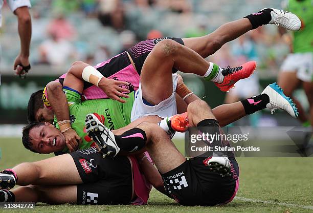 Jordan Rapana of the Raiders is tackled during the round one NRL match between the Canberra Raiders and the Penrith Panthers at GIO Stadium on March...