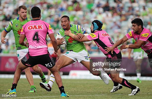 Joseph Leilua of the Raiders is tackled during the round one NRL match between the Canberra Raiders and the Penrith Panthers at GIO Stadium on March...