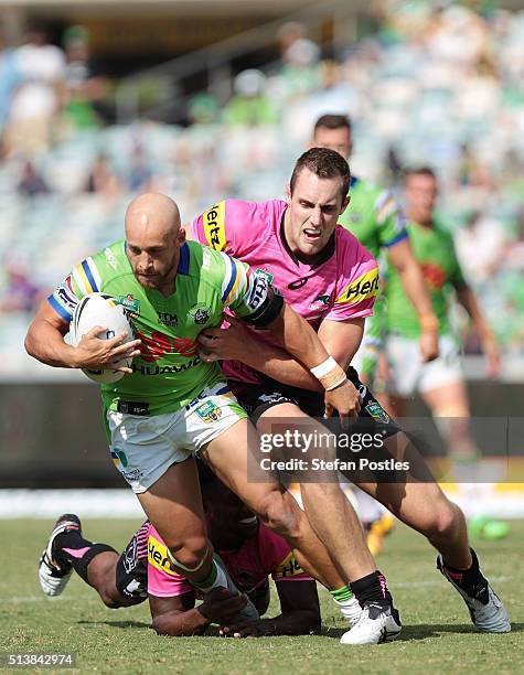 Kurt Baptiste of the Raiders is tackled during the round one NRL match between the Canberra Raiders and the Penrith Panthers at GIO Stadium on March...