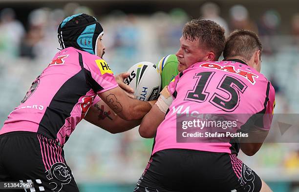 Elliot Whitehead of the Raiders is tackled during the round one NRL match between the Canberra Raiders and the Penrith Panthers at GIO Stadium on...