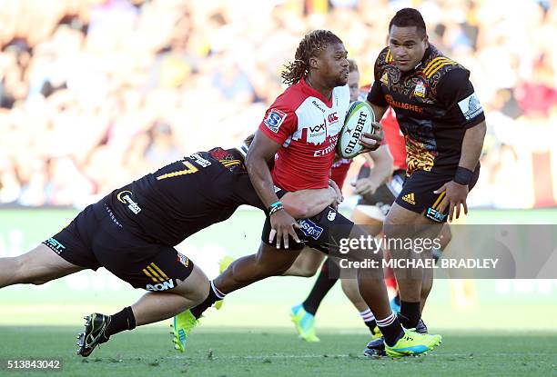 South Africa's Golden Lions player Howard Mnisi is tackled by the Waikato Chiefs' Mitchell Graham during during the Super Rugby match between the...