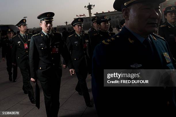 Military delegates arrive at the Great Hall of the People during the opening ceremony of the National People's Congress in Beijing on March 5, 2016....