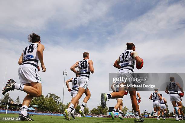 Cats players run out during the 2016 AFL NAB Challenge match between the Essendon Bombers and the Geelong Cats at Deakin Resserve on March 5, 2016 in...