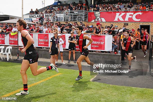 Mitch Brown and Jake Long of the Bombers run onto the ground during the 2016 AFL NAB Challenge match between the Essendon Bombers and the Geelong...