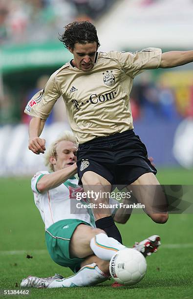 Owen Hargreaves of Munich is tackled by Magnin of Bremen during The Bundesliga match between Werder Bremen and FC Bayern Munich at The Weser Stadium...