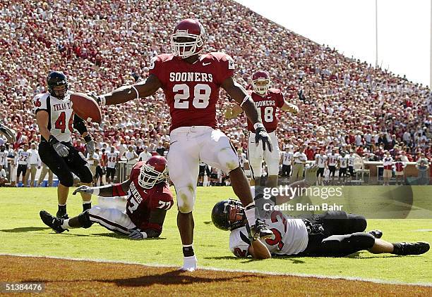 Freshman running back Adrian Peterson of the Oklahoma Sooners slips into the endzone with only one shoe for a touchdown against the Texas Tech Red...