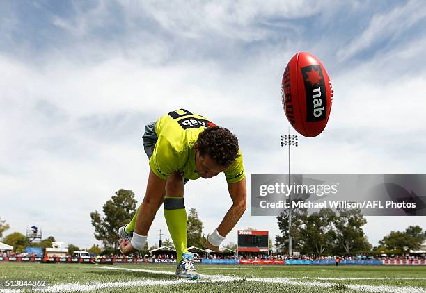 Umpire Shane McInerney bounces the ball during the 2016 NAB Challenge match between the Essendon Bombers and the Geelong Cats at Deakin Reserve,...