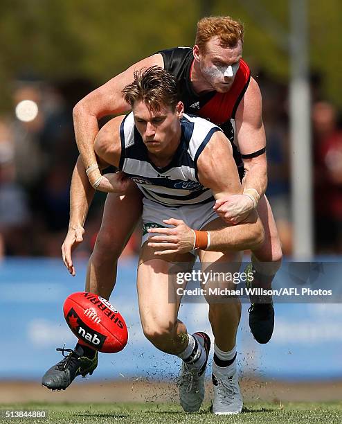 Mark Blicavs of the Cats and Adam Cooney of the Bombers compete for the ball during the 2016 NAB Challenge match between the Essendon Bombers and the...