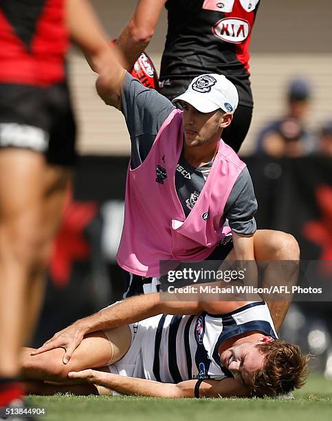 Jackson Thurlow of the Cats lays injured during the 2016 NAB Challenge match between the Essendon Bombers and the Geelong Cats at Deakin Reserve,...