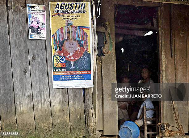 Ninos indigenas juegan junto a un cartel del candidato municipal Agustin Hernandez Hernandez de la Convergencia PAN-PRD-PT de Mexico, en la localidad...