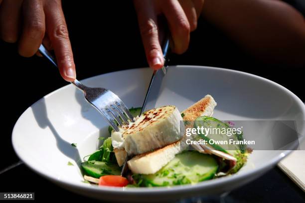 eating a goat cheese salad - queso de cabra fotografías e imágenes de stock