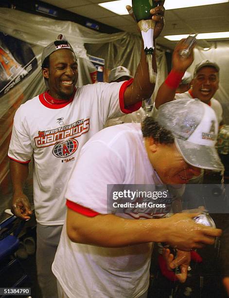 Vladimir Guerrero of the Anaheim Angels showers teammate Bartolo Colon with champagne following the Angels 5-4 victory over the Oakland A's to clinch...