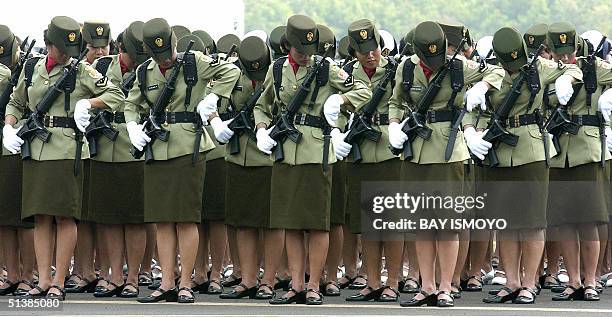 Indonesia Army women gets ready to mount bayonet on their weapons during the rehearsal of the 59th anniversary of the creation of the Indonesian...