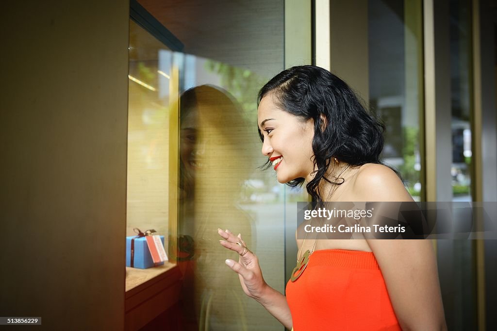 Woman smiling looking at a store display