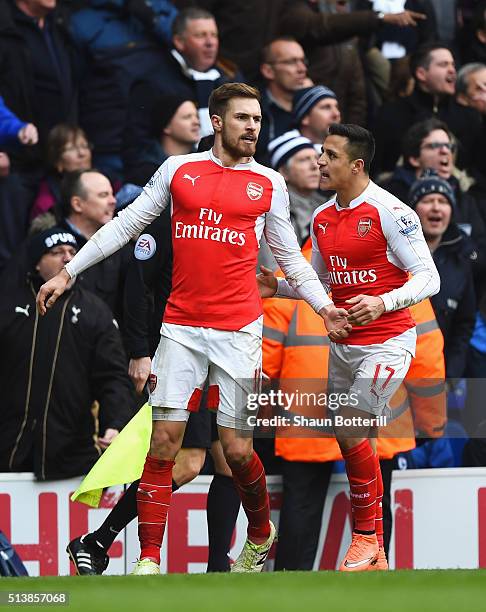 Aaron Ramsey of Arsenal celebrates scoring his team's first goal with his team mate Alexis Sanchez during the Barclays Premier League match between...