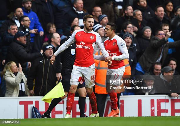 Aaron Ramsey of Arsenal celebrates scoring his team's first goal with his team mate Alexis Sanchez during the Barclays Premier League match between...
