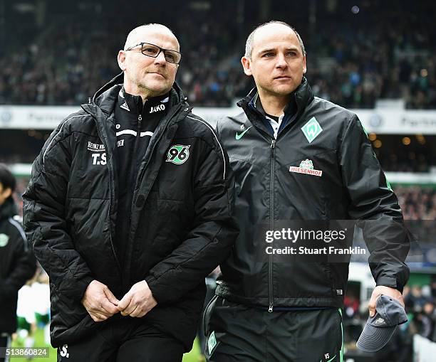 Thomas Schaaf, head coach of Hannover walks out with Viktor Skripnik, head coach of Bremen during the Bundesliga match between Werder Bremen and...