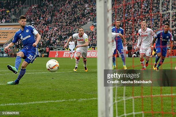 Klaas-Jan Huntelaar of Schalke scores the opening goal from a penalty during the Bundesliga match between 1. FC Koeln and FC Schalke 04 at...