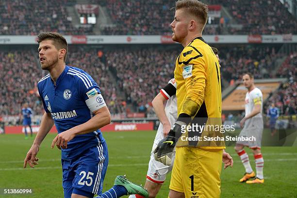 Klaas-Jan Huntelaar of Schalke celebrates after scoring the opening goal from a penalty as goalkeeper Timo Horn of Koeln looks dejected during the...