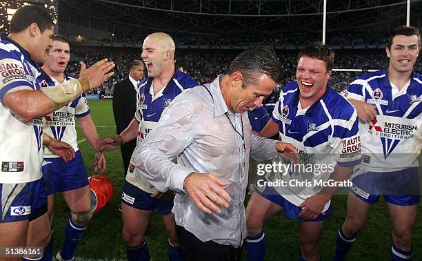 Bulldogs coach Steve Folkes stands dripping after being dumped with Gatorade during the NRL Grand Final between the Sydney Roosters and the Bulldogs...