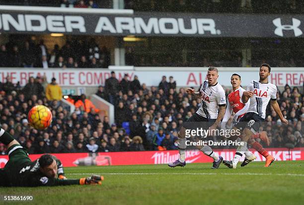 Alexis Sanchez scores Arsenal's 2nd goal under pressure from Toby Alderweireld and Mousa Dembele of Tottenham during the Barclays Premier League...