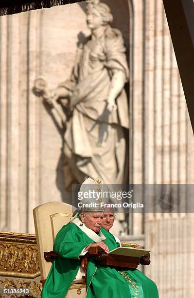 Pope John Paul II sits during the beatification ceremony in St. Peter's Square October 3 , 2004 in Vatican City. Pope John Paul II named five...