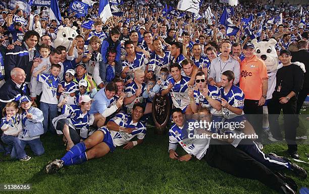 Bulldogs players pose for a team photo in front of their fans after defeating the Roosters during the NRL Grand Final between the Sydney Roosters and...