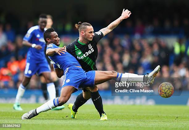 John Mikel Obi of Chelsea and Marko Arnautovic of Stoke City compete for the ball during the Barclays Premier League match between Chelsea and Stoke...
