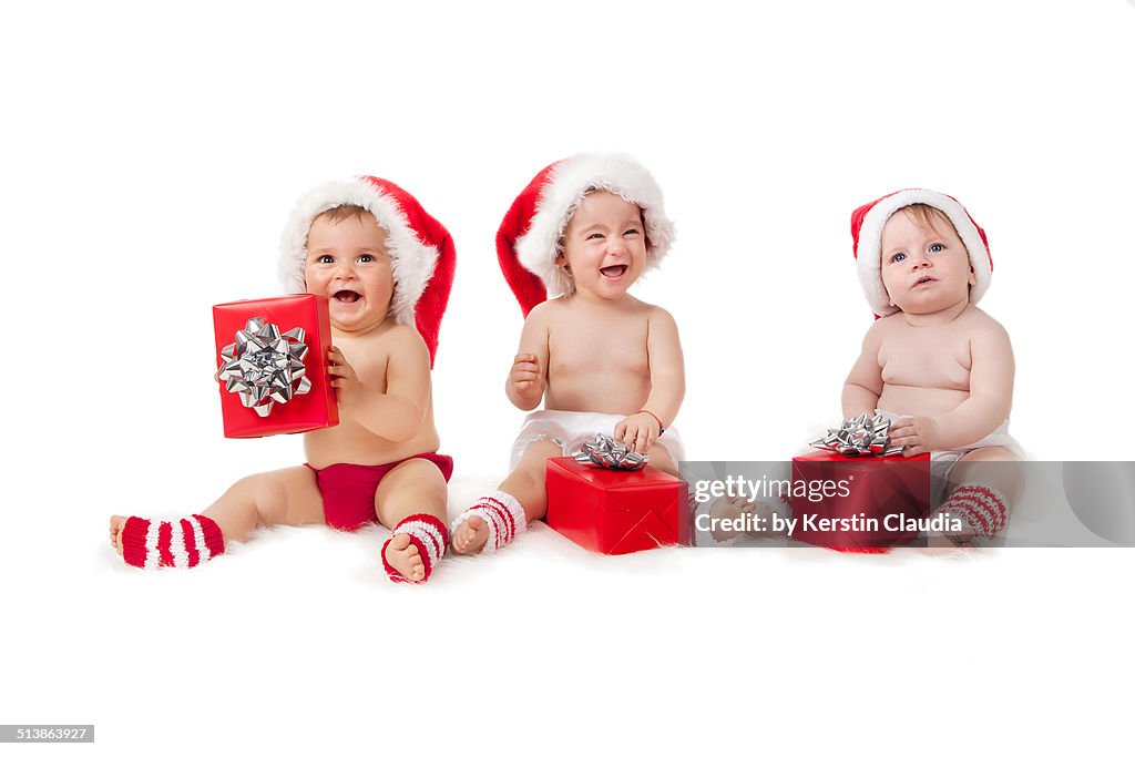 Happy babies with Christmas gifts