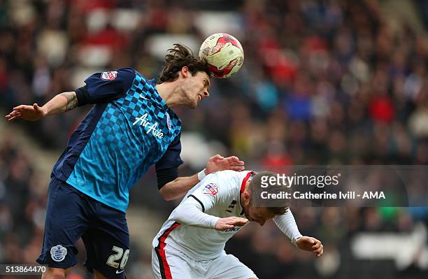 Gabriele Angella of Queens Park Rangers gets above Dean Bowditch of MK Dons during the Sky Bet Championship match between MK Dons and Queens Park...
