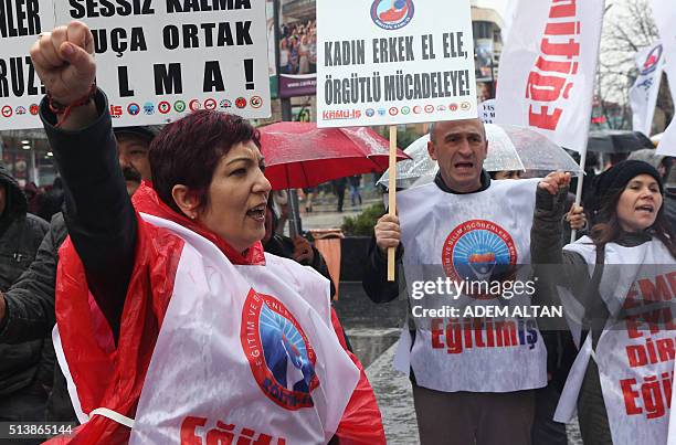 Turkish members of labor unions and civil society groups shout slogans before upcoming International Women's Day in Ankara on March 5, 2016. The...